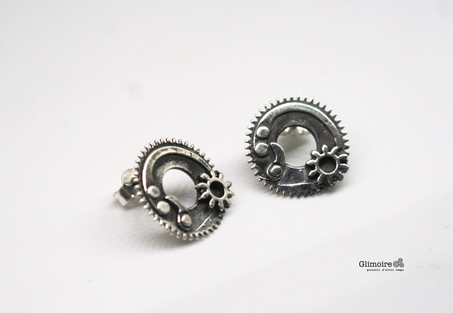 Orecchini ingranaggi in argento dal design steampunk di Glimoire con dettagli meccanici circolari
