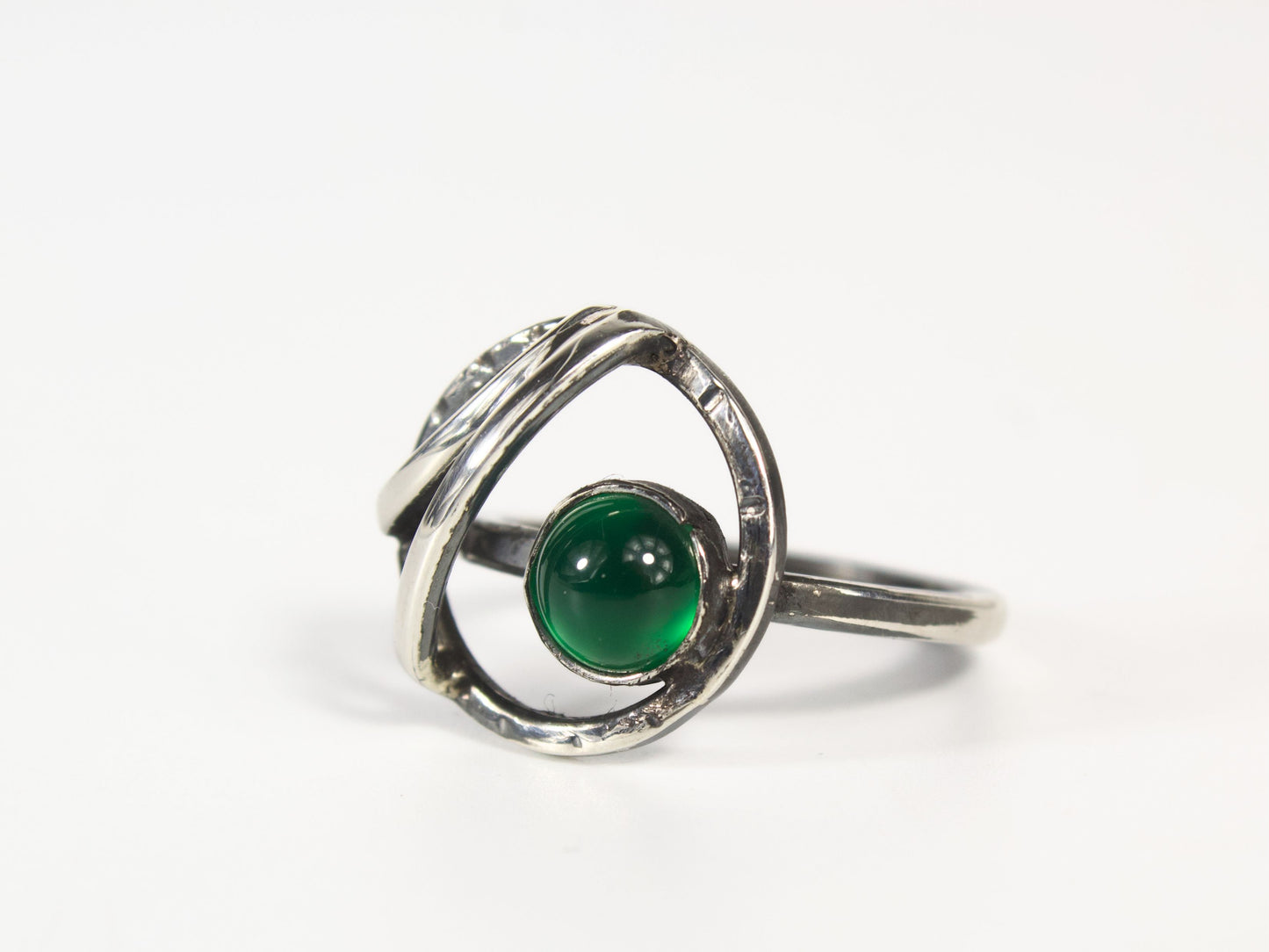 Anello della collezione Orbite, realizzato a mano in argento con pietra verde centrale. Ispirato ai movimenti dei corpi celesti.
