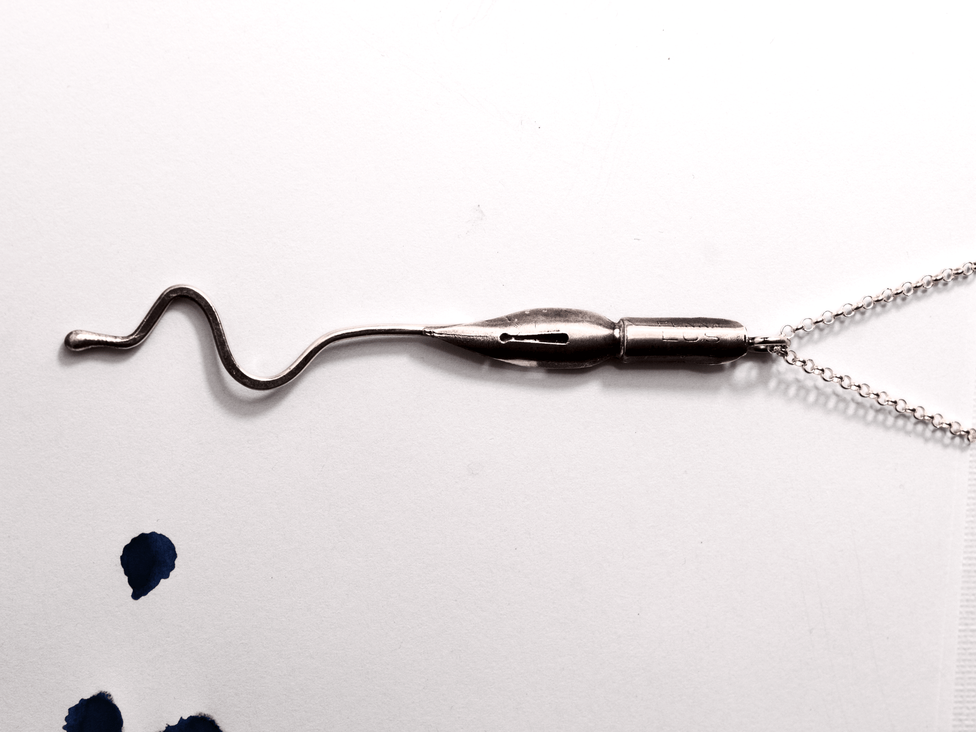 Collana artigianale con ciondolo pennino d'epoca da scrittura su sfondo bianco