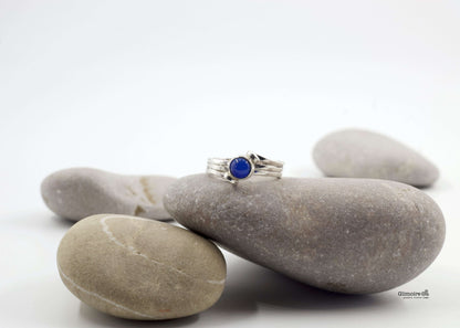 Anello in argento pietra blu Glimoire su sassi lisci grigi design a fasce sottili